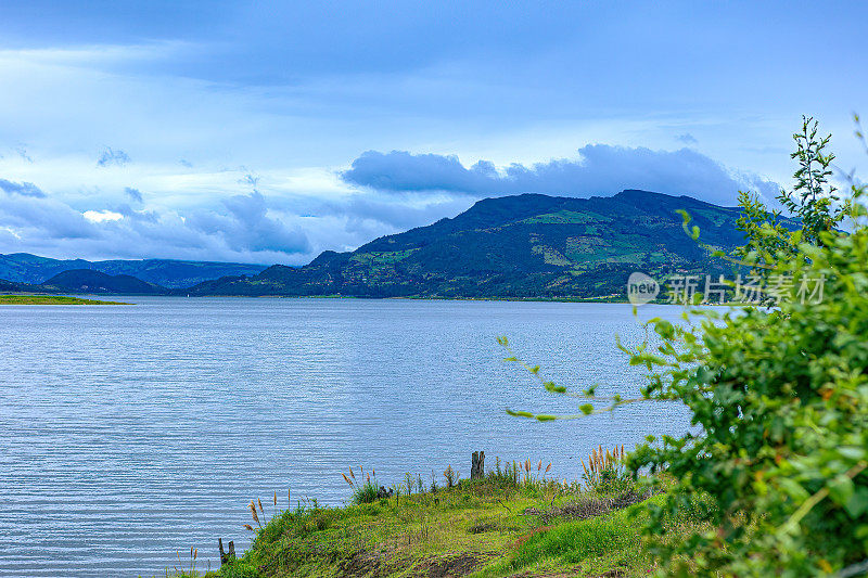 哥伦比亚瓜达维塔:从赤陶土瓦屋顶俯瞰Tominé Reservoir Or Embalse Del Tominé和安第斯山脉之外